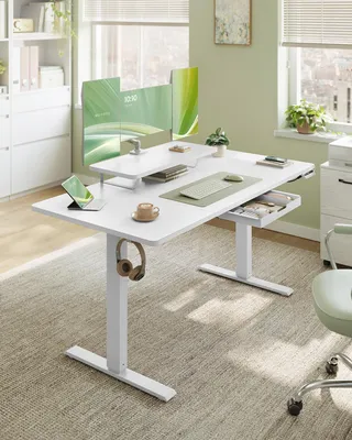 A modern home office setup with a standing desk, monitors, and accessories.