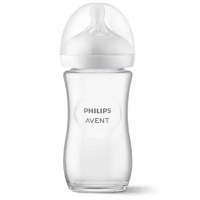 A clear studio shot of a glass baby bottle with a white nipple and cap.