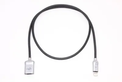 A black charging cable with silver connectors is laid out in a loop on a white background.