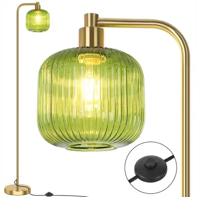 A close-up view of a green glass floor lamp with a gold finish.