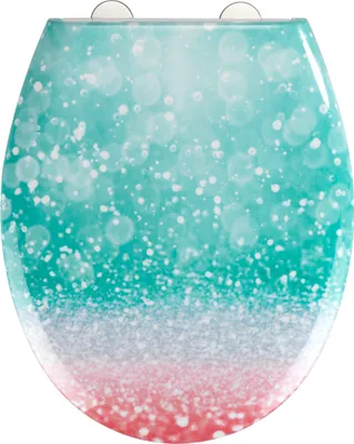 A toilet seat with a gradient design of teal and pink with white bubbles.