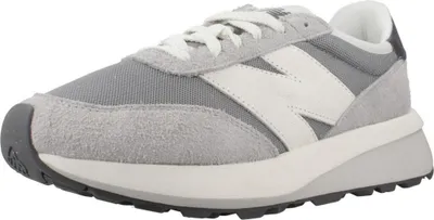 A studio shot of a single New Balance sneaker.