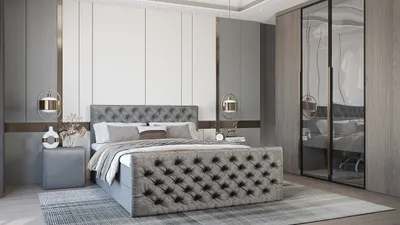 A modern bedroom with a large tufted bed, nightstand, and wardrobe with mirrored doors.