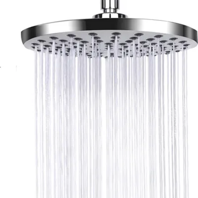 A close-up shot of a round shower head with water spraying from it.