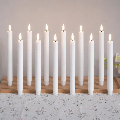 Immagine prodotto di 12 candele a LED a forma di bastoncino, luce bianco caldo, 25 cm, senza fiamma, alimentate a batteria, ideali per decorazioni natalizie, matrimoni, feste e altri eventi, colore bianco
