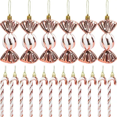 A collection of Christmas ornaments shaped like candy canes and wrapped candies, arranged in two rows against a white background.