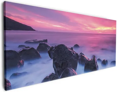 Produktbild von Wallario Premium Leinwandbild Felsen im Meer bei Sonnenuntergang in Größe 50 x 125 cm
