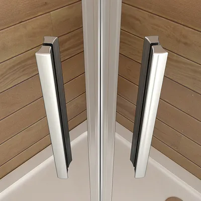 Close-up of shower door handles and frame in a corner of a shower stall.