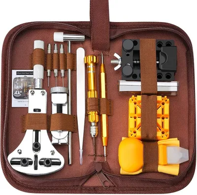A brown zippered case containing a watch repair tool kit.
