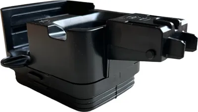 A black plastic part for a coffee machine.