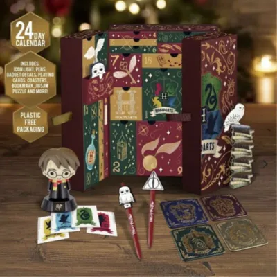 A Harry Potter themed advent calendar with various items displayed around it.