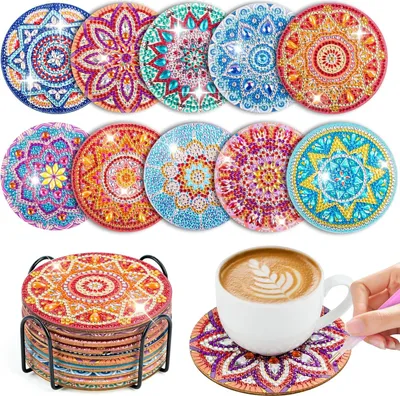 A collection of diamond painting coasters with a holder and a cup of coffee on a coaster.