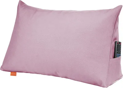 A pink lumbar pillow with a remote control in its side pocket.