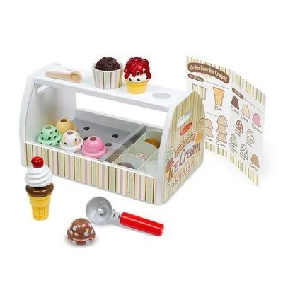 A wooden toy ice cream counter with various ice cream scoops, cones, and accessories.