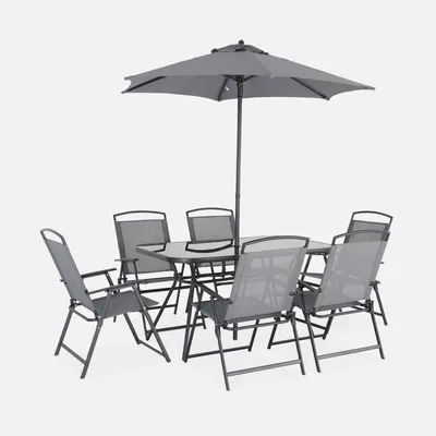 A grey outdoor dining set with a table, six chairs, and a parasol, presented against a plain white background.