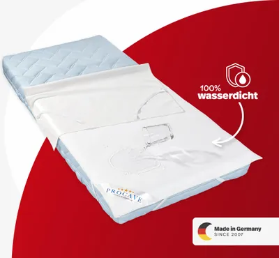 A mattress protector is shown on a mattress, with water spilled on it to demonstrate its waterproof quality. The background is a split of white and red.
