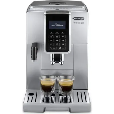 A DeLonghi Dinamica automatic coffee machine is shown from the front, with two cups of espresso in the foreground.