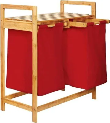 A product shot of a bamboo laundry basket with two red fabric bags.