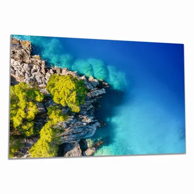 Produktbild von Wallario Herdabdeckplatte aus Glas, Größe 80 x 52 cm 1-teilig, Motiv Felsige Küste mit Bäumen von oben