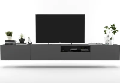 A modern, wall-mounted TV cabinet with a television and decorative items.