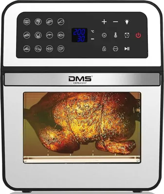 A close-up front view of a DMS® 12L air fryer oven with a whole roasted chicken inside.