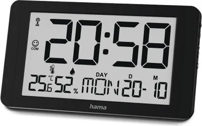 A digital wall clock displaying time, date, temperature, and humidity.