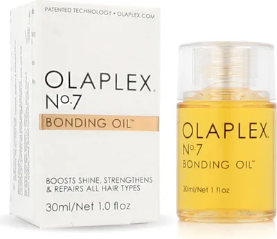 A product box and bottle of Olaplex No. 7 Bonding Oil.