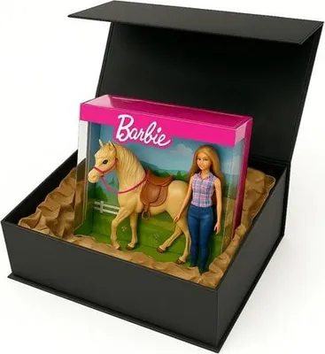 A Barbie doll and horse set is displayed inside an open black gift box.