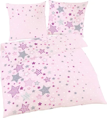 A pink bedding set with a star pattern, including a duvet cover and pillowcases, laid out on a white background.