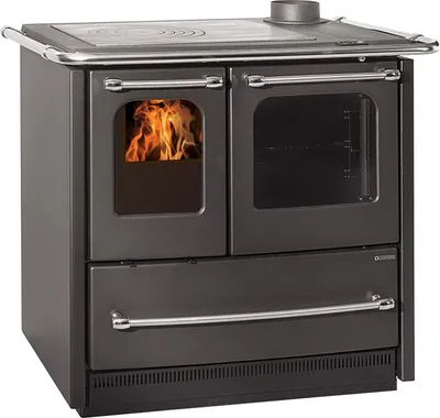 A freestanding wood-burning stove with a visible fire in one compartment and an oven in another.