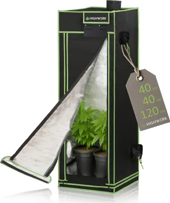 A black and green indoor grow tent with the front flap open, revealing two potted plants inside. A tag with product dimensions is attached to the side.