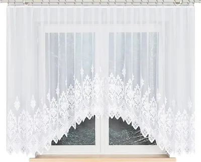 A white lace curtain with a decorative pattern is hung over a window.