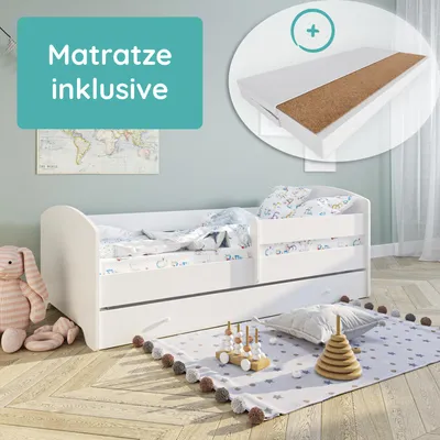 A child's bed with bedding, a toy bunny, and a rug with toys on it, set in a bedroom.