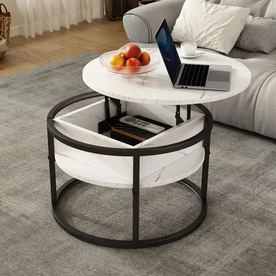 A modern living room scene with a coffee table in the foreground, a laptop, fruit bowl, and a sofa in the background.