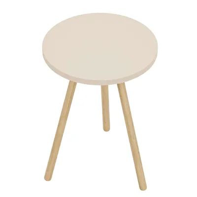 A round, cream-colored side table with three wooden legs, photographed from a top-down diagonal angle.