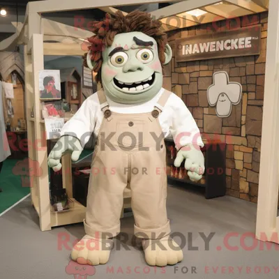 Obrázok produktu pre Maskot spoločnosti REDBROKOLY, béžové monštrum pripomínajúce Frankenšteina, oblečené v pracovných nohaviciach (džínsach) s náprsníkovými vreckami