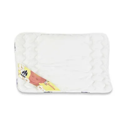 A white baby quilt with a colorful label featuring a baby's face and text.