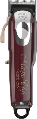 A close-up, studio shot of a red Wahl Magic Clip cordless hair clipper against a white background.