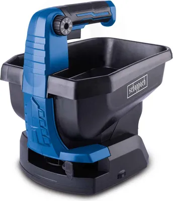 A product shot of a handheld spreader on a white background.