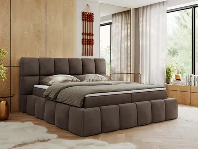A bedroom scene with a large bed as the focal point.