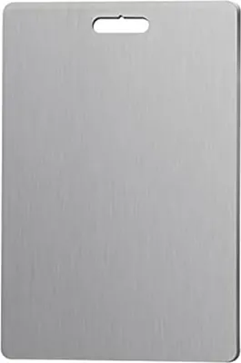 A plain, top-down view of a rectangular stainless steel cutting board with a hole at the top for hanging.