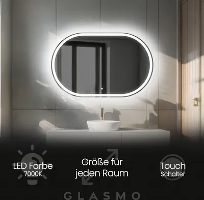 A modern bathroom with an illuminated oval mirror above a sink.