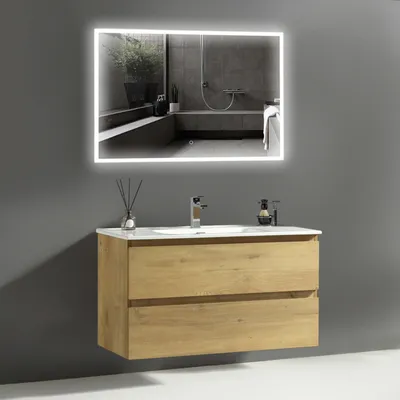A modern bathroom vanity with a sink, faucet, and a lighted mirror.