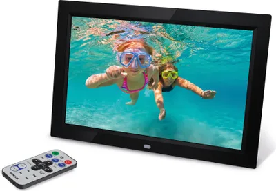 A digital photo frame displaying an image of two children swimming underwater, with a remote control in the foreground.
