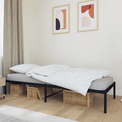 A bedroom scene with a bed frame, mattress, pillows, and bedding.