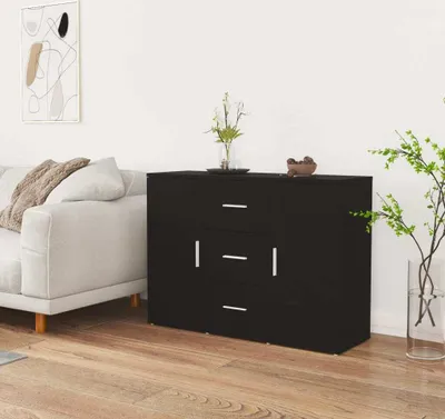 A black sideboard is placed in a living room next to a sofa.