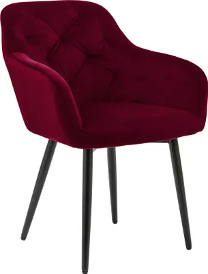 A single red velvet armchair with black metal legs against a white background.