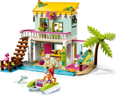 A LEGO Friends beach house set with a boat and figures on a white background.