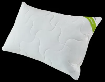 A white pillow with a quilted pattern and a green label on the corner.