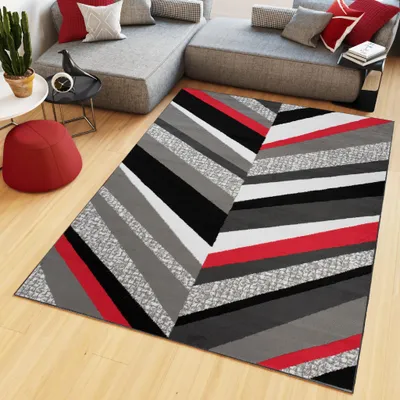 A modern living room with a sectional sofa, a rug, and decorative items.